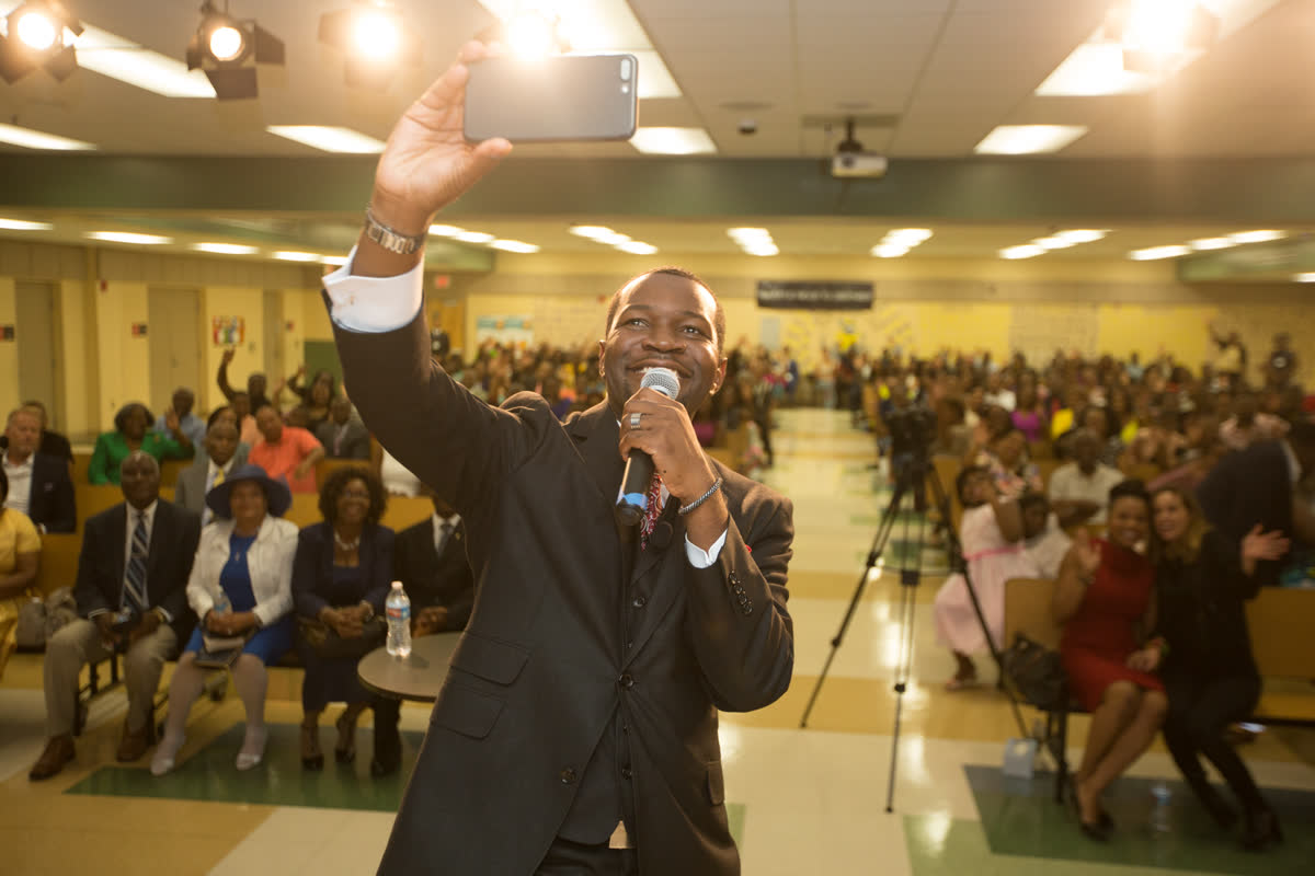 Pastor Duma Alphonse on stage leading worship at Crown Church Orlando